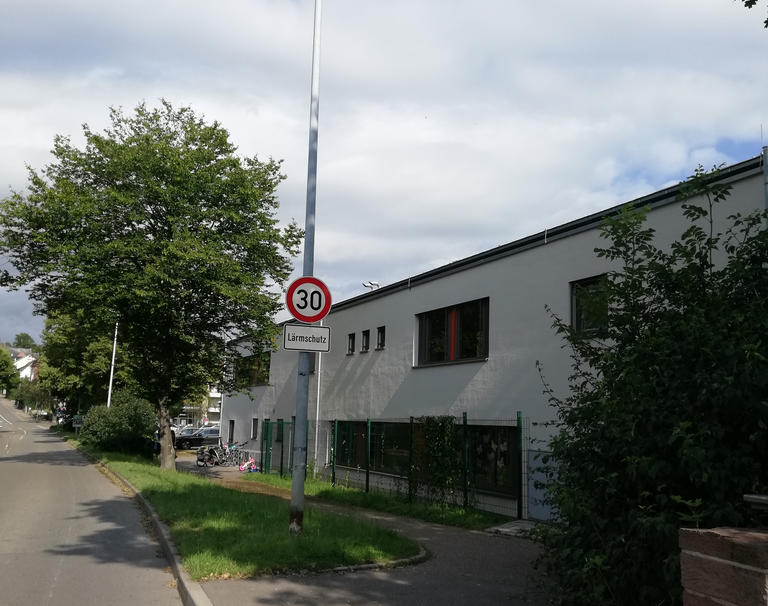 Am Straßenrand steht das Verkehrsschild Tempo 30 mit dem Zusatz "Lärmschutz".