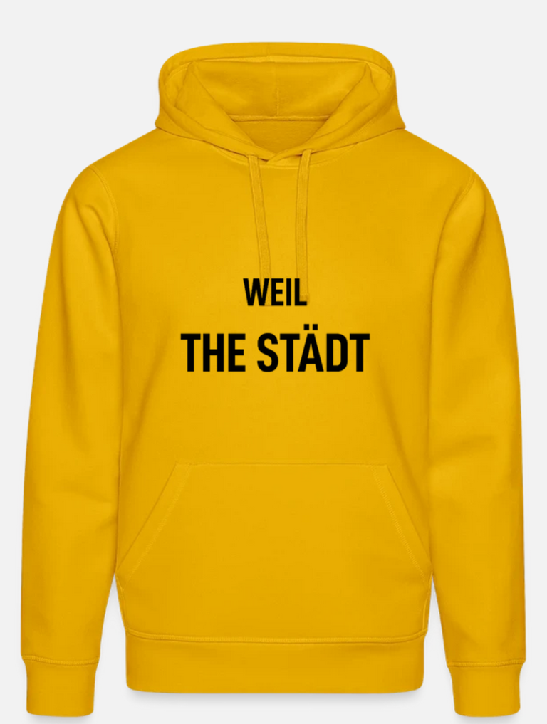 Ein gelber Hoodie mit der schwarzen Aufschrift "WEIL THE STÄDT" auf der Vorderseite.