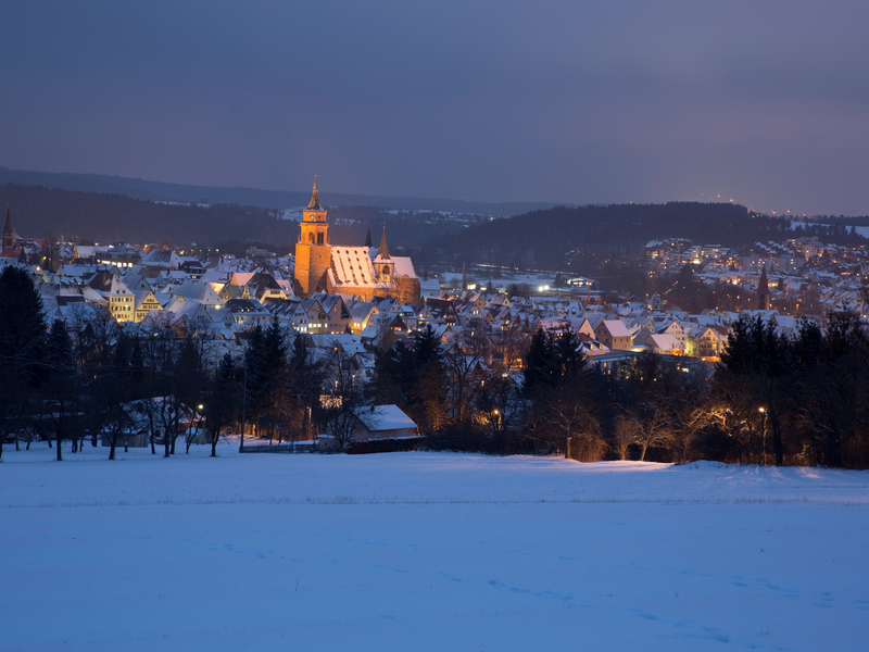 Winterliche Stadtansicht mit beleuchteter St. Peter und Paul Kirche